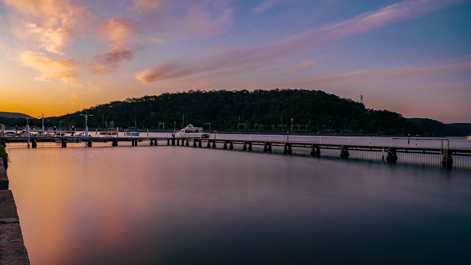 a body of water with a dock in the middle of it
